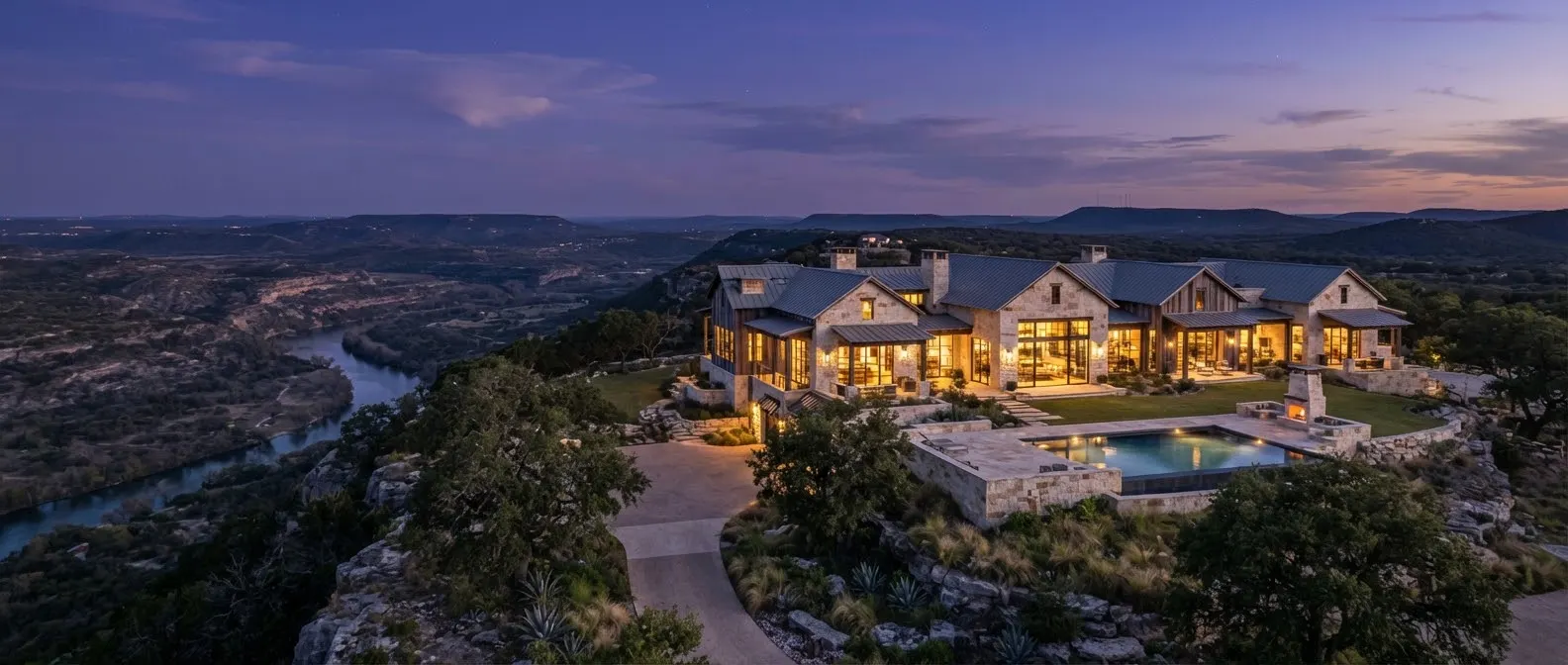 A modern cut-limestone ranch estate perched on a high ridge overlooking the Blanco River valley in Texas.